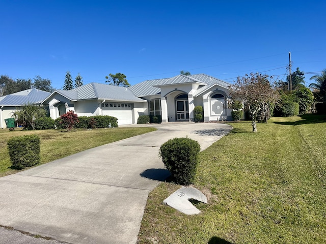 view of front of house featuring a garage and a front lawn