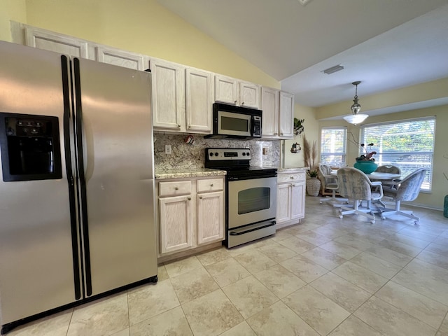 kitchen featuring lofted ceiling, backsplash, hanging light fixtures, stainless steel appliances, and light stone counters