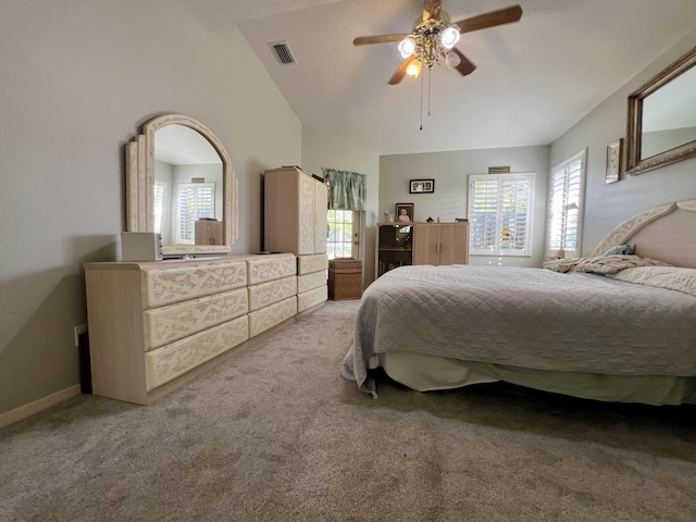 bedroom featuring vaulted ceiling, light colored carpet, and ceiling fan