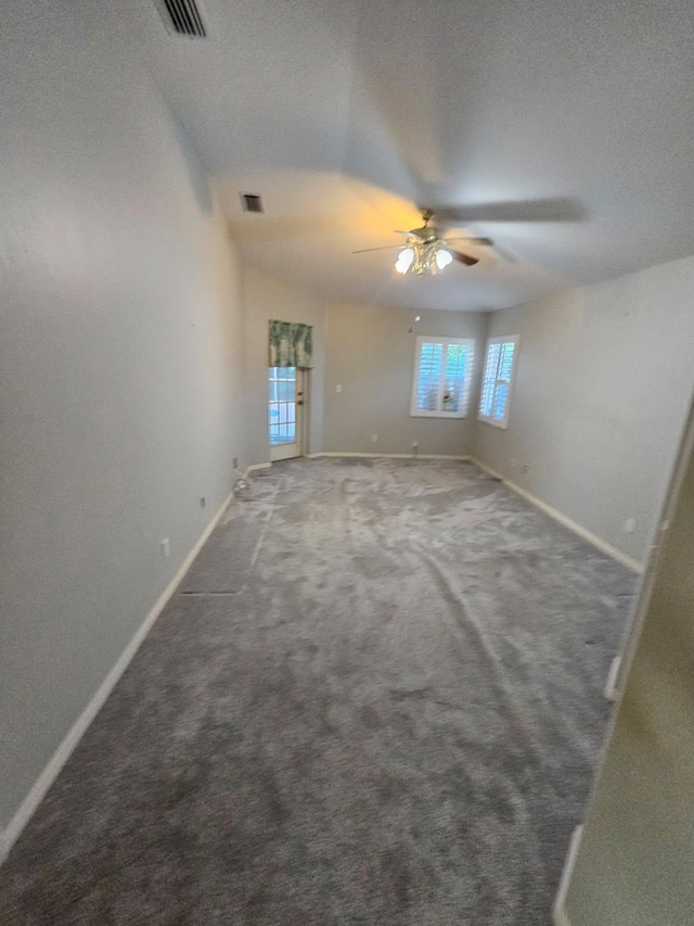 carpeted spare room featuring ceiling fan and a textured ceiling