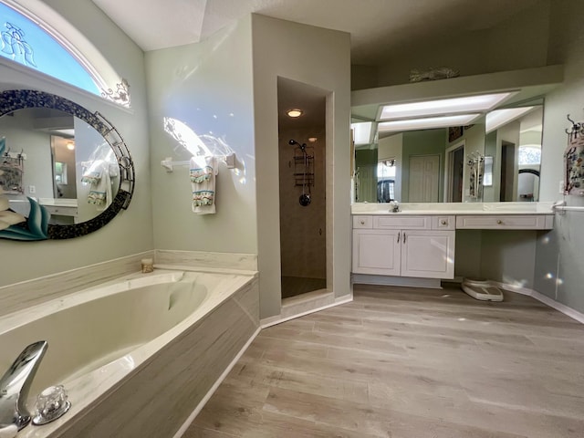 bathroom featuring vanity, hardwood / wood-style floors, and separate shower and tub