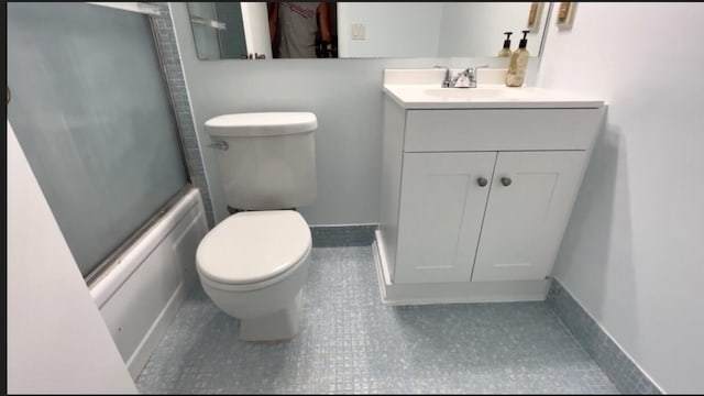 full bathroom with tile patterned flooring, enclosed tub / shower combo, vanity, and toilet