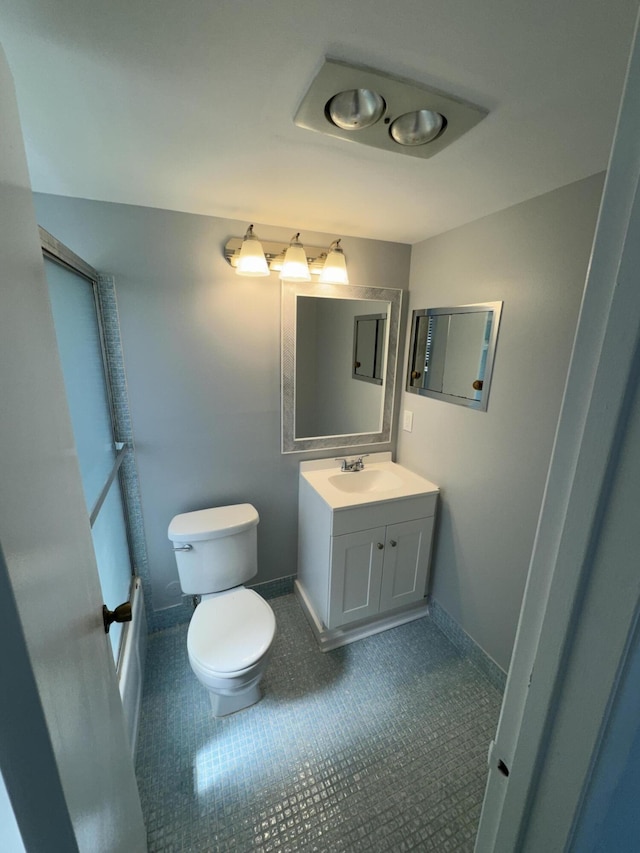 bathroom with vanity, tile patterned floors, and toilet