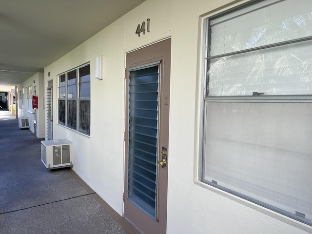 doorway to property featuring a wall mounted AC