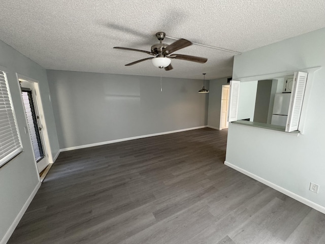 unfurnished living room featuring a textured ceiling, dark hardwood / wood-style floors, and ceiling fan