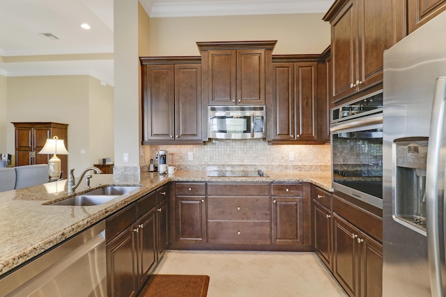 kitchen with sink, crown molding, stainless steel appliances, tasteful backsplash, and light stone countertops