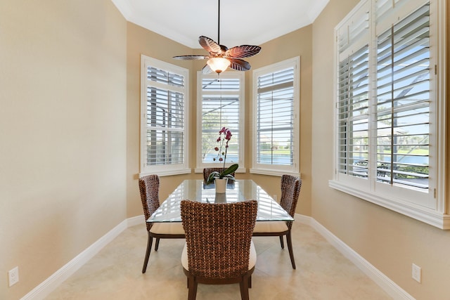 dining space with ornamental molding and ceiling fan