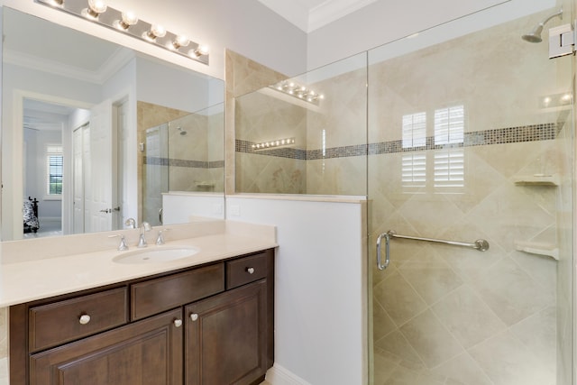 bathroom with ornamental molding, an enclosed shower, and vanity