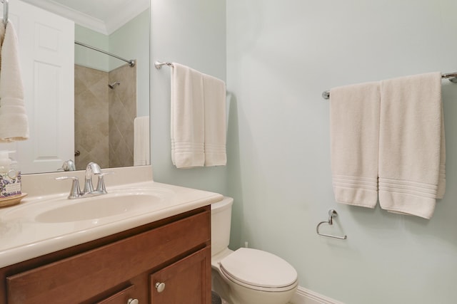 bathroom featuring vanity, ornamental molding, and toilet