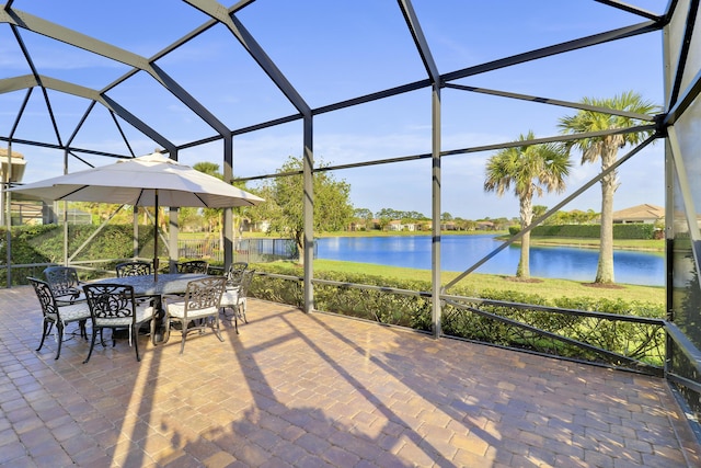 view of patio / terrace with a lanai and a water view