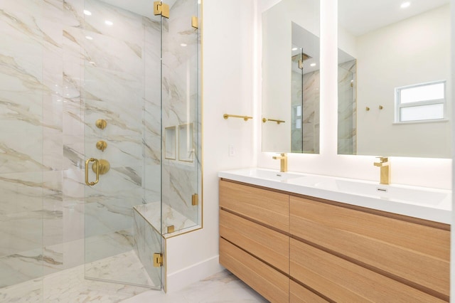 full bathroom with baseboards, marble finish floor, a sink, and a marble finish shower