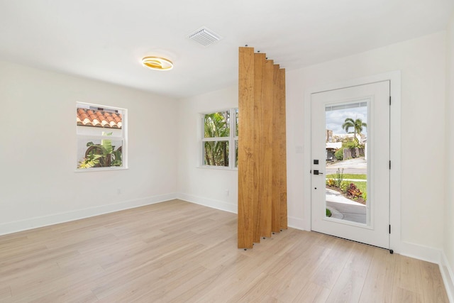 entryway featuring visible vents, light wood-style flooring, and a healthy amount of sunlight
