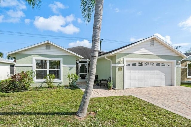 single story home featuring a garage and a front lawn