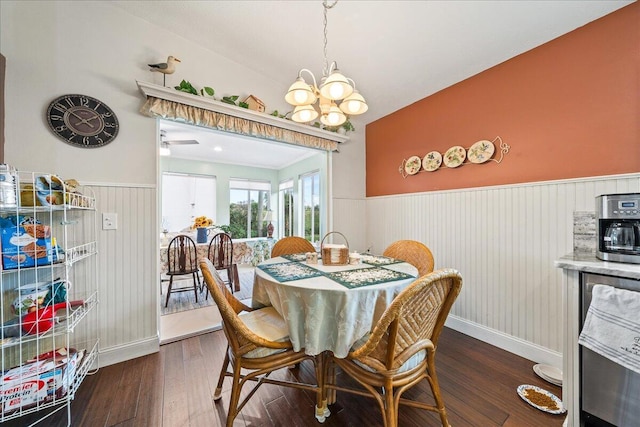 dining space with dark hardwood / wood-style flooring and a chandelier