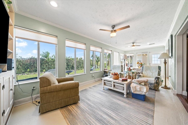 sunroom / solarium featuring ceiling fan