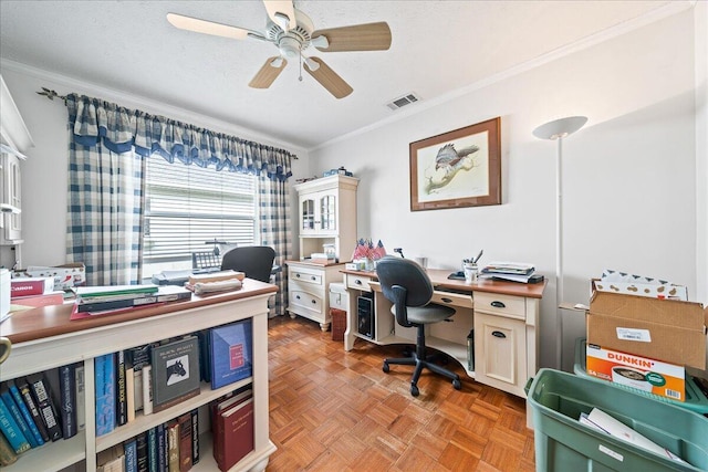 office space featuring light parquet flooring, a textured ceiling, ceiling fan, and crown molding