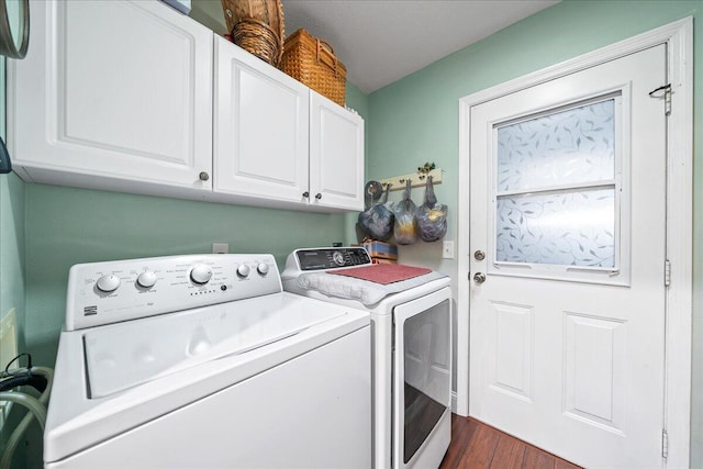 laundry room featuring cabinets, dark hardwood / wood-style floors, and independent washer and dryer