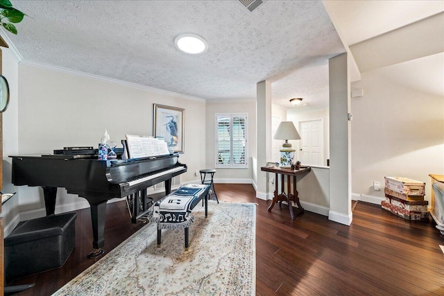 misc room featuring dark hardwood / wood-style flooring, ornamental molding, and a textured ceiling