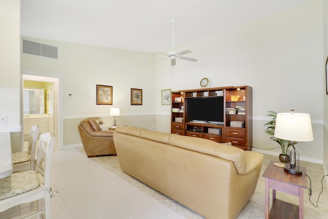 tiled living room with ceiling fan