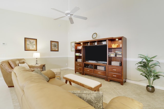 living room featuring a towering ceiling, ceiling fan, and light tile patterned flooring