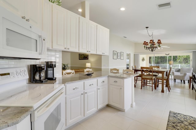 kitchen featuring light tile patterned floors, kitchen peninsula, pendant lighting, white appliances, and white cabinets