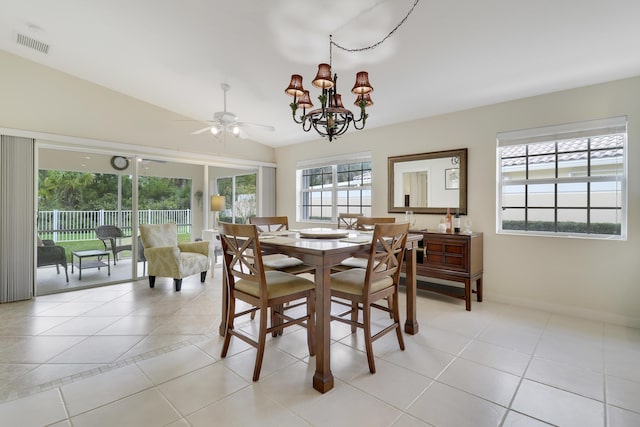 dining area with light tile patterned flooring, lofted ceiling, and ceiling fan with notable chandelier