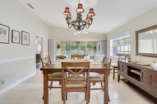 dining area featuring light tile patterned flooring, lofted ceiling, and an inviting chandelier