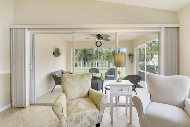 living area with ceiling fan and light tile patterned floors