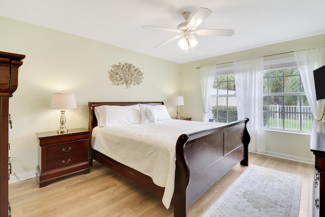 bedroom with ceiling fan and light hardwood / wood-style flooring