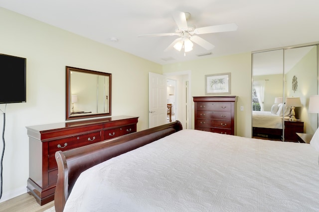 bedroom with ceiling fan and a closet