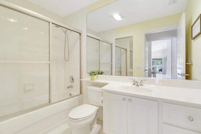 full bathroom with bath / shower combo with glass door, vanity, and toilet