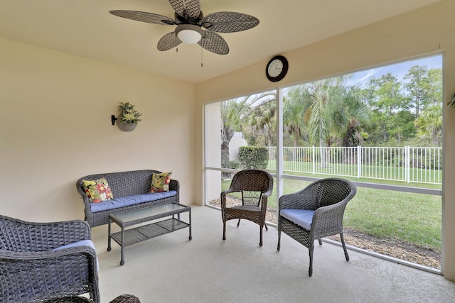 sunroom / solarium featuring ceiling fan