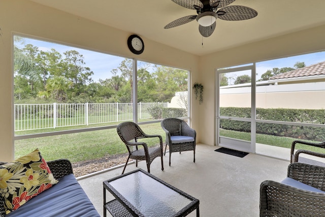 sunroom / solarium featuring ceiling fan