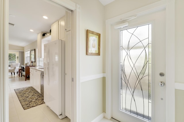 entryway with light tile patterned floors