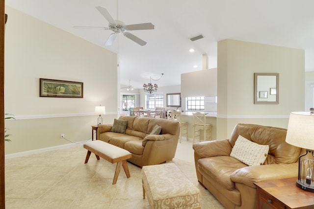 tiled living room featuring ceiling fan with notable chandelier and high vaulted ceiling