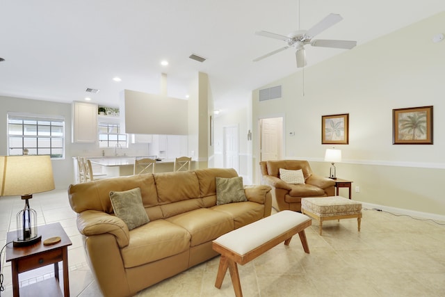 tiled living room with high vaulted ceiling, sink, and ceiling fan