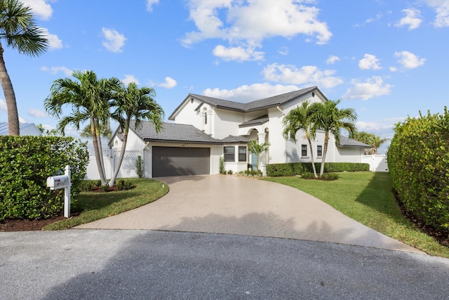 view of front of house with a garage and a front yard