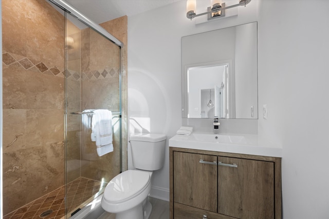 bathroom featuring vanity, an enclosed shower, and toilet