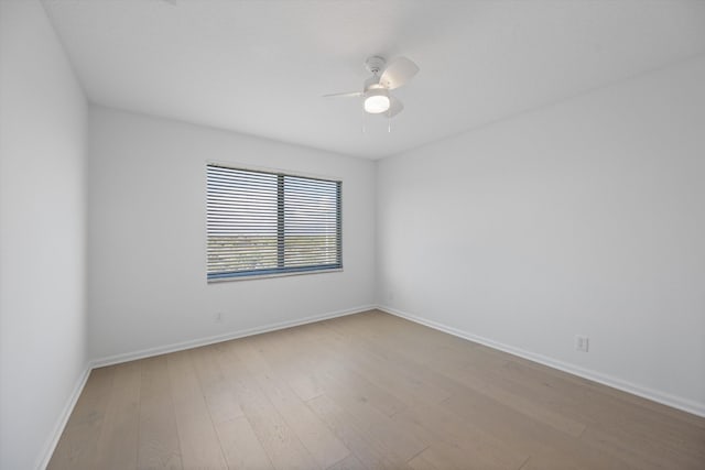 spare room featuring light hardwood / wood-style flooring and ceiling fan