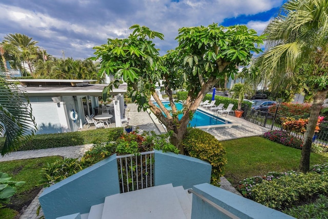 exterior space featuring a community pool and a patio area