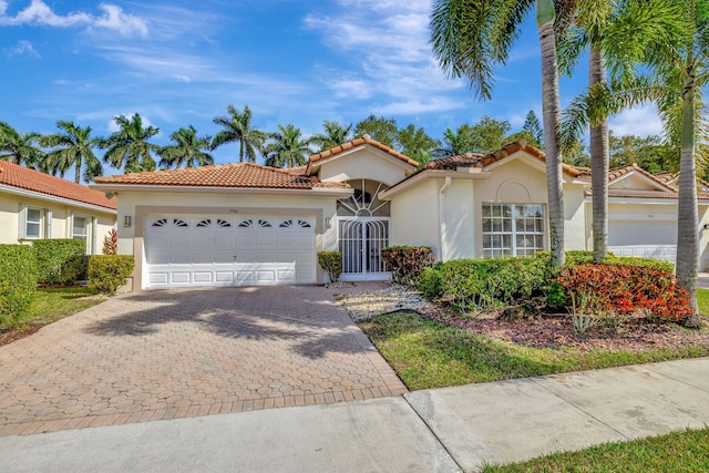 mediterranean / spanish-style home featuring a garage