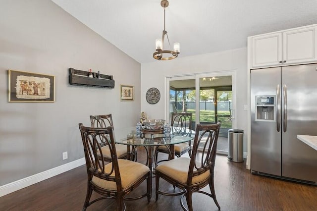 dining area with vaulted ceiling, dark wood-type flooring, and an inviting chandelier