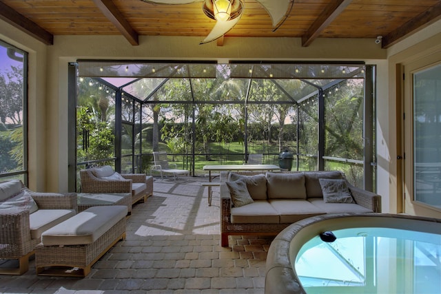 unfurnished sunroom with beam ceiling and wooden ceiling