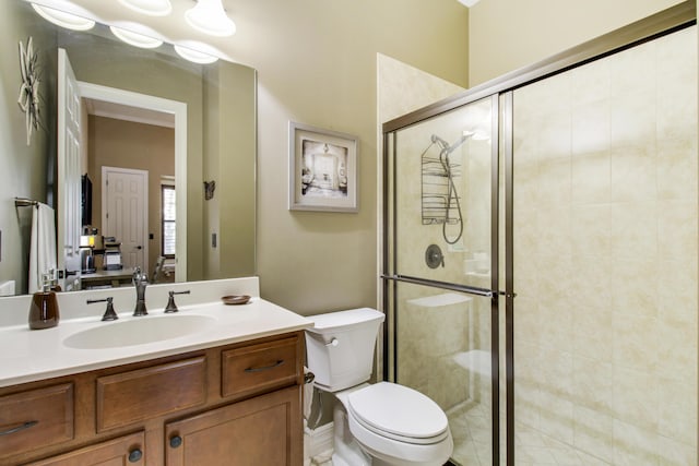 bathroom featuring vanity, an enclosed shower, and toilet