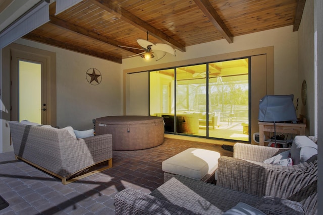 view of patio with ceiling fan, a hot tub, and an outdoor hangout area