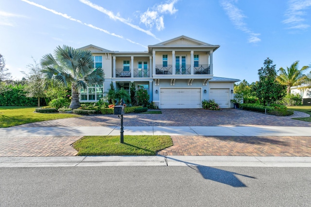 view of front of home with a garage and a balcony