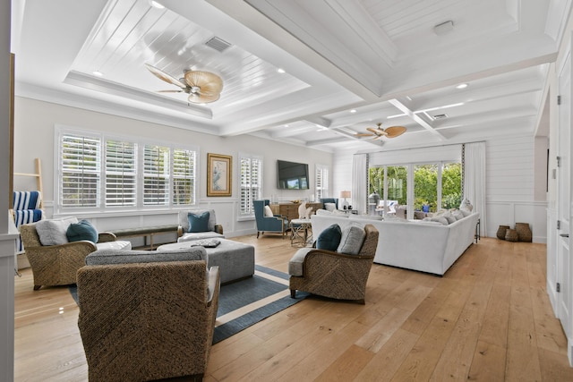 living room featuring a healthy amount of sunlight, ceiling fan, and light hardwood / wood-style floors