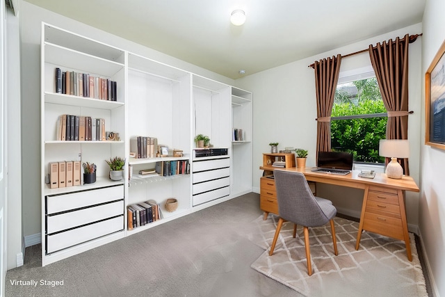 carpeted office space featuring baseboards