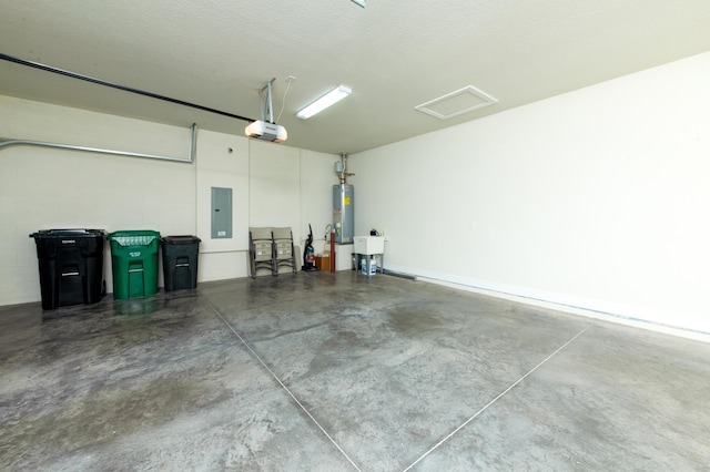 garage featuring a sink, water heater, electric panel, a garage door opener, and concrete block wall