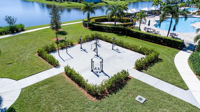 exterior space with a water view and a lawn